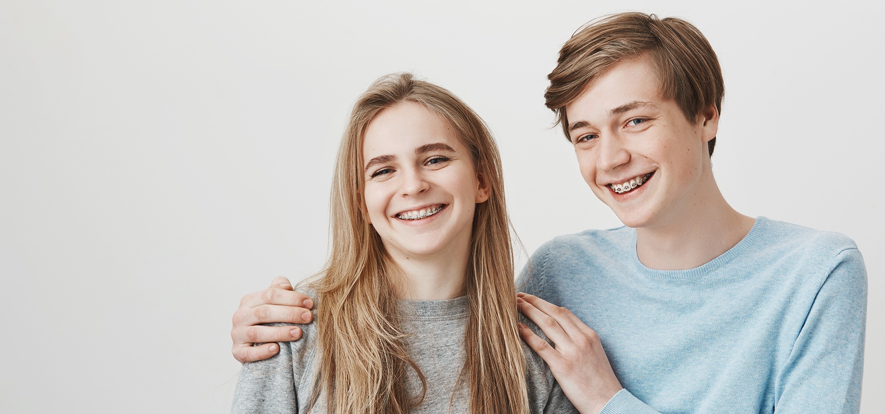 Two teens with braces smiling