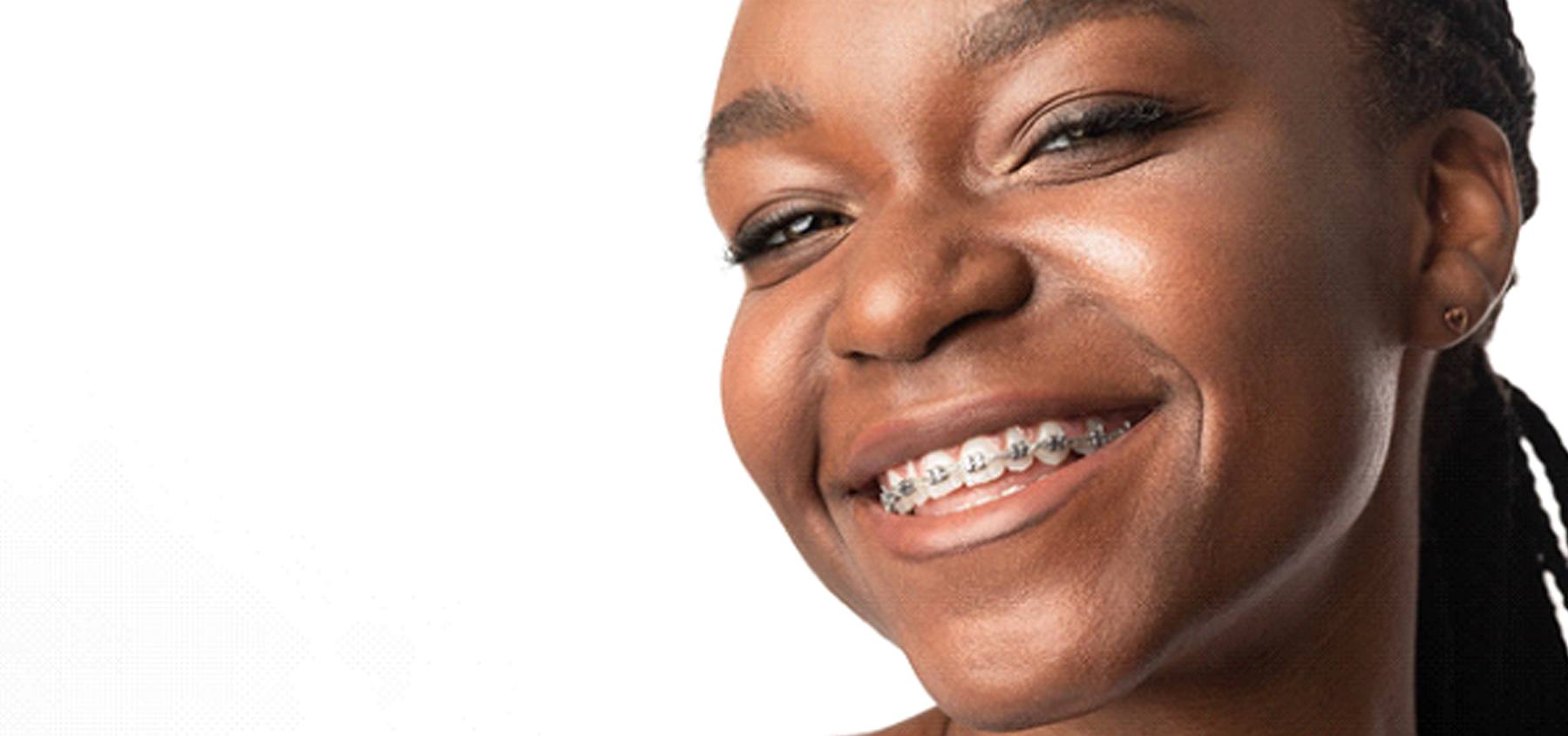 Smiling girl with metal braces in Frisco on white background
